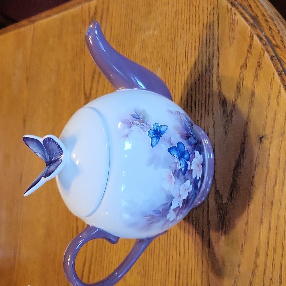A Very Pretty teapot with a floral and butterfly pattern